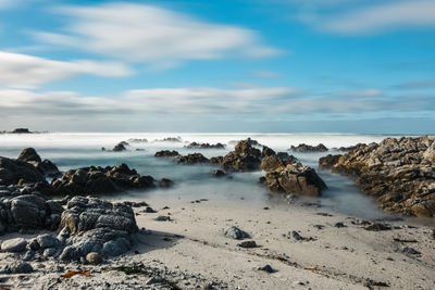 Long camera exposure of pacific ocean waves on rocky california coast