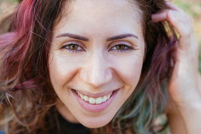 Close-up portrait of smiling woman outdoors