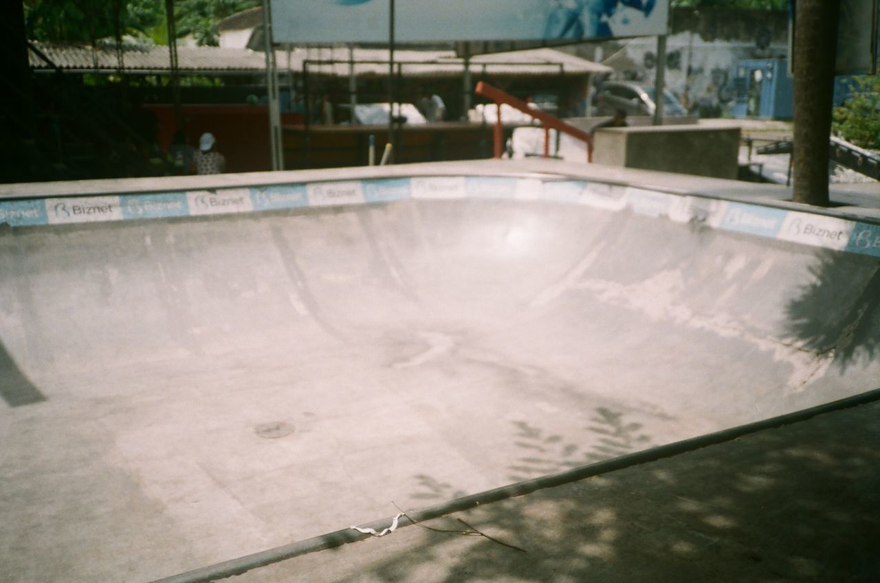 HIGH ANGLE VIEW OF SWIMMING POOL AGAINST BUILDING