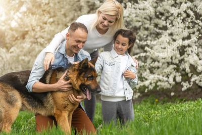 Happy family members with dog at park