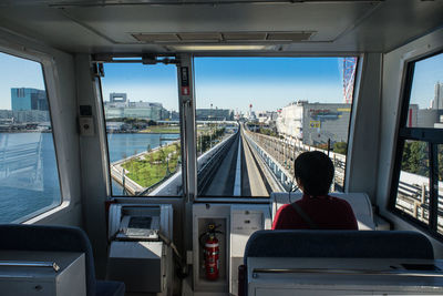 Rear view of person sitting in cable car