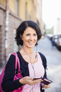 Smiling mature woman with earphones