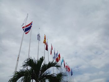 Low angle view of flags against sky