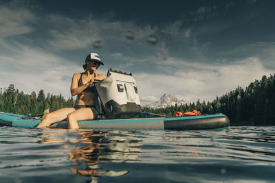 A young woman enjoys a standup paddle board on lost lake in oregon.