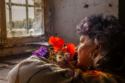 Senior romantic lady with fresh flowers