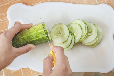 Midsection of person holding vegetables