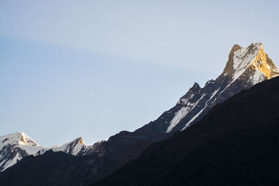 Scenic view of snowcapped mountains against clear sky