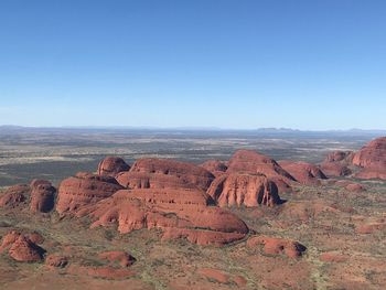 Scenic view of dramatic landscape against blue sky