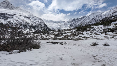 Scenic view of snow covered mountains against sky