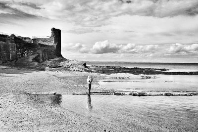 Man standing on beach against sky