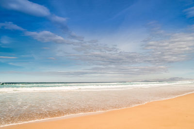 View of beach against cloudy sky