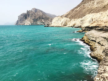 Scenic view of sea and mountains against sky