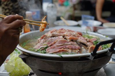 Close-up of person preparing food on table