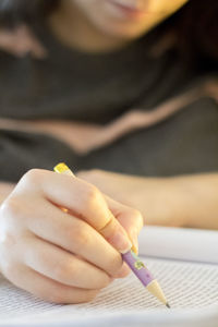 Close-up of woman hand holding book