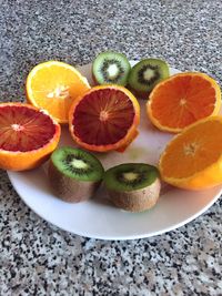 Close-up of fruit slices in plate on flooring