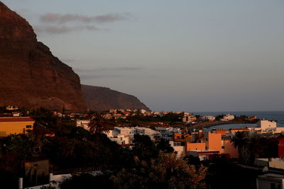 High angle view of townscape by sea against sky