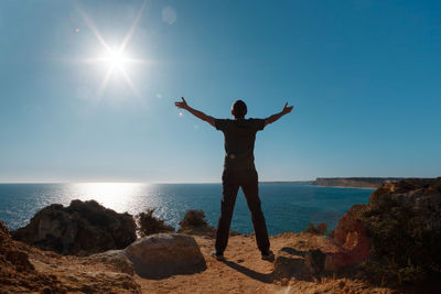 Man standing in sea against clear sky