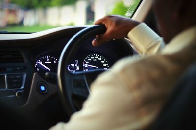 Rear view of man driving car