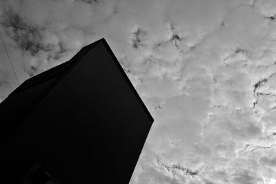 Low angle view of building against cloudy sky
