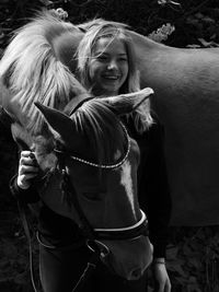 Portrait of young woman with horse