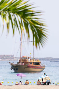 Boats moored on sea against sky