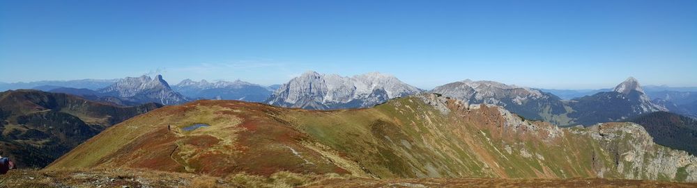 Scenic view of mountains against clear blue sky