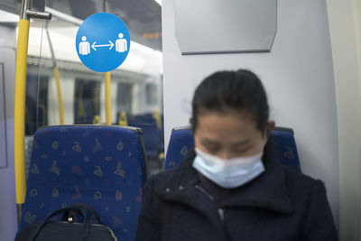 Woman wearing face mask in train
