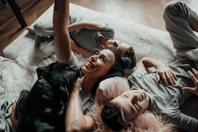 High angle view of people relaxing on bed