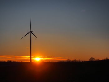 Silhouette of wind turbines at sunset