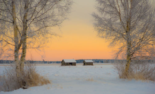 Scenic view of frozen lake against sky during sunset