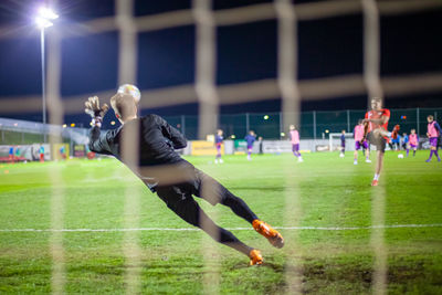 People playing soccer on field