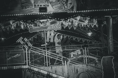 Close-up of illuminated ferris wheel at night