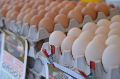 Close-up of eggs in crates for sale at market