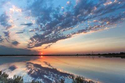 Scenic view of lake against romantic sky at sunset