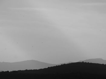 Scenic view of silhouette mountains against clear sky