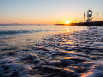 Scenic view of sea against clear sky during sunset