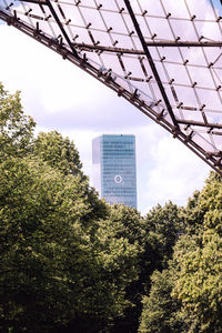 Low angle view of trees and buildings against sky