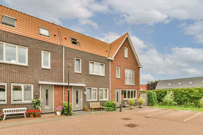 Houses on field against sky