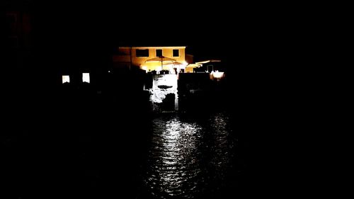 Illuminated buildings by street at night