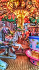 Illuminated carousel in amusement park