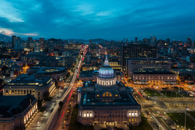 High angle view of city lit up at night