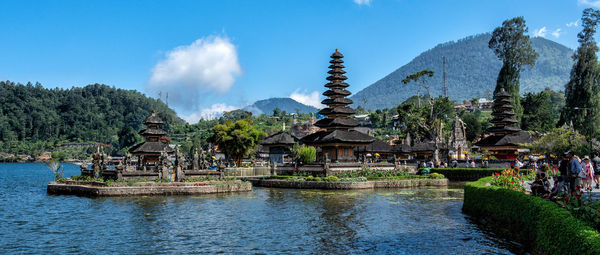 Panoramic view of lake and buildings against sky