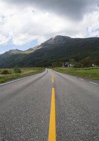 Surface level of empty road against mountain range
