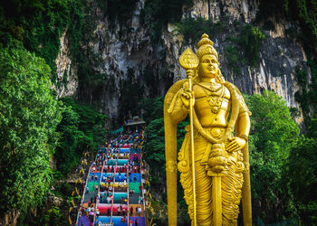 Statue of buddha against trees