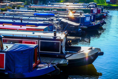 High angle view of boats moored at harbor during sunny day