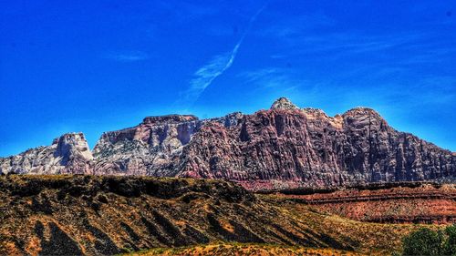 Low angle view of rock formation against blue sky