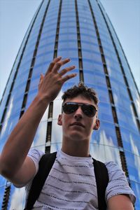 Low angle view of teenage boy against tower