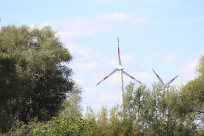 Low angle view of windmill against sky