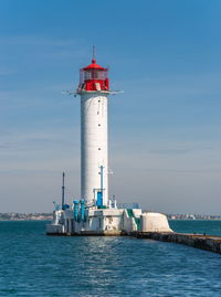 Lighthouse at the entrance to the harbor of odessa seaport, on a sunny summer day