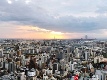 High angle view of modern buildings against sky during sunset